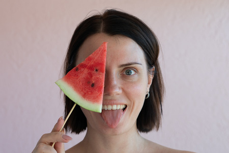 portrait of a girl with a slice of watermelonの写真素材