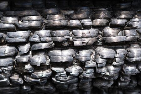 texture of black burned wooden log wall outsideの写真素材