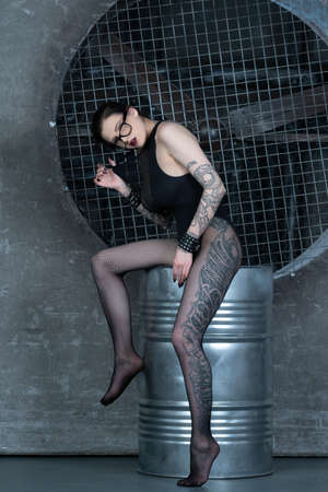 young beautiful woman posing in black bodysuit in the studioの写真素材