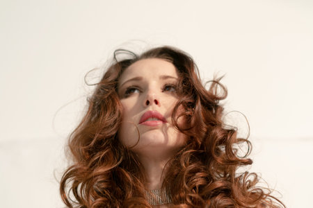 portrait of a young pretty woman with fluffy hair in the studioの写真素材