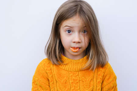 portrait of a little girl in the studio with candyの写真素材