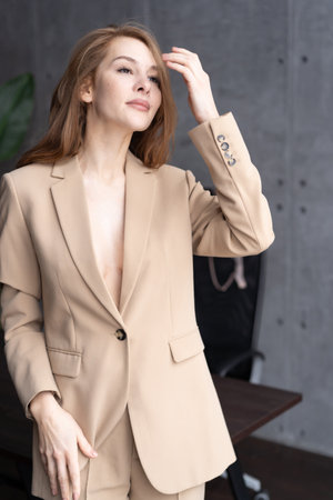 portrait of a beautiful fashionable woman in a beige suit.の写真素材