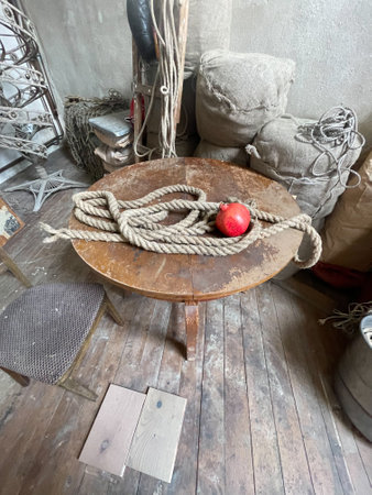 Wooden chair with rope and red apple in the interior of an old houseの写真素材