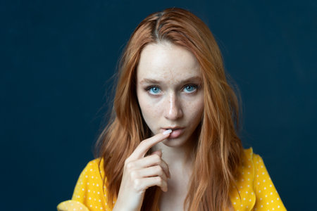 Portrait of a redhead girl with freckles on her faceの写真素材