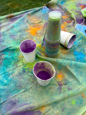 Colorful paint pots on a green and purple background. Selective focus.の写真素材