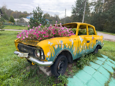 Vintage car with flowers on the roof in the villageの写真素材