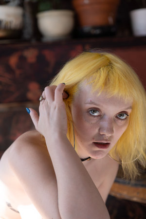 Portrait of a beautiful young woman with yellow hair and blue eyesの写真素材