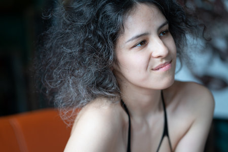 Portrait of a young beautiful asian woman with curly hair.の写真素材