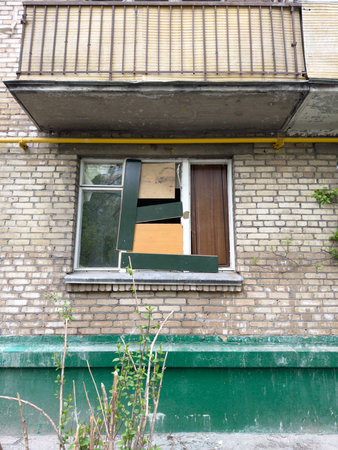 Old window with green shutters on a brick wall in the streetの写真素材