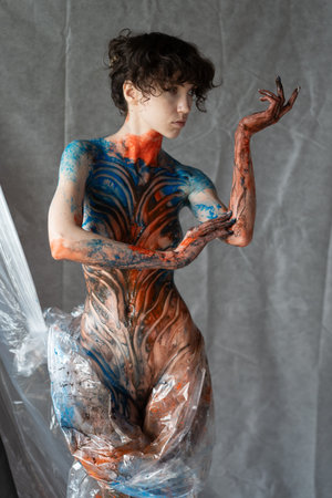 Artistic body painting. Beautiful young woman with artistic body painting.の写真素材