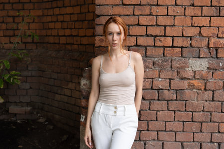 Beautiful redhead girl with freckles posing in an urban contextの写真素材