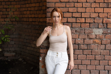 Beautiful redhead girl with freckles posing on the street.の写真素材