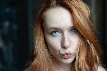 Portrait of beautiful redhead girl with freckles on her faceの写真素材
