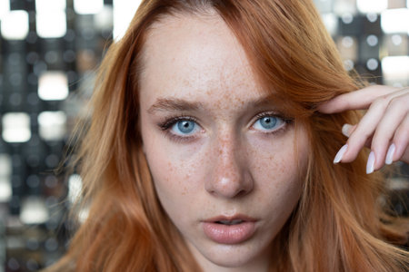 Portrait of a red-haired girl with freckles on her faceの写真素材