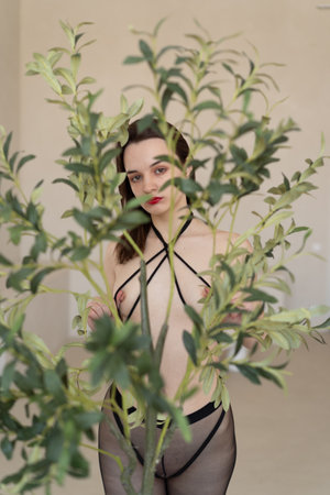 young beautiful girl in black lingerie posingの写真素材