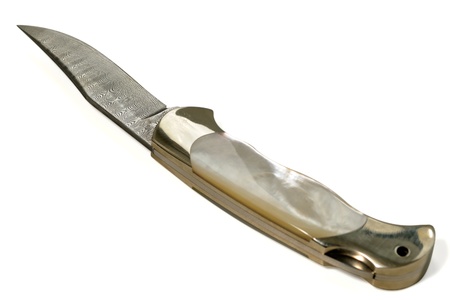 Hunting knife with a ornate blade and mother-of-pearl handle on white background 