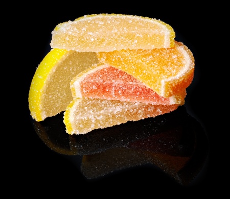 Stack of citrus fruit jellies on black mirror background. Studio shot, not isolatedの写真素材