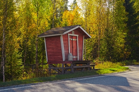 Country road with aluminum bins for fresh milk at autumn in Finlandの写真素材