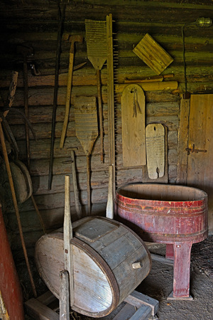 Old rustic peasant farmhouse laundry with wooden washing machine, wringer, washtub. Equipment from the early twentieth century. Hiiumaa open-air museum Soera farm.のeditorial素材