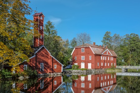 Traditional red ochre painted colour wooden houses at Stromfors Iron Works, Finland.  Iron works was founded in the westernmost junction of the Kymijoki River in 1698. StrÃ¶mfors Iron Works got its name in 1744.のeditorial素材