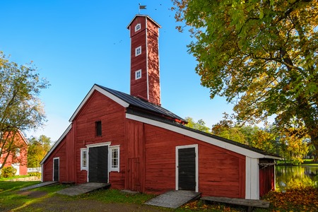 Old factory hose tower of red ochre painted wood at Stromfors Iron Works, Finland.  Iron works was founded in the westernmost junction of the Kymijoki River in 1698. Stromfors Iron Works got its name in 1744.のeditorial素材