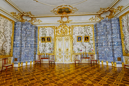 Ornate interior of the Catherine Palace with a multi-tiered tiled stove with cobalt painting....