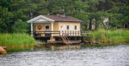 Finnish wooden sauna on shore of lake