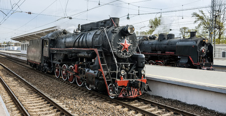 Old soviet steam locomotives series L and SO at railway station.