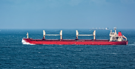 Container freighter ship sailing in stormy oceanの写真素材