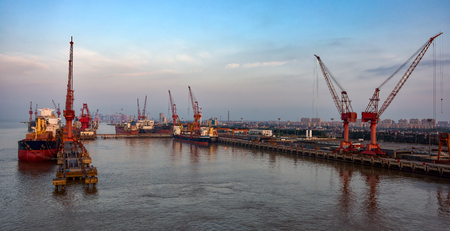 Cargo ships and cranes at Shanghai shipyard, China