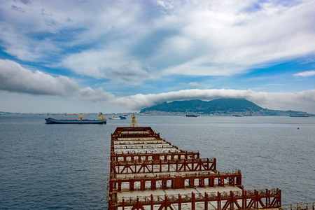 Industrial container ship enters the Strait of Gibraltar, view on the bow from the captain bridge....