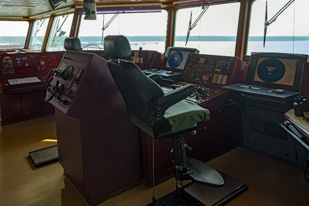 Wheelhouse of modern container ship with various navigational equipment during an stay in the port