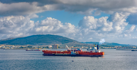 Refuelling or bunkering in marine terms is carried out using a small tanker to pump the bunker fuel into the bigger ship.の写真素材