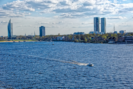 Embankment of the River Daugava with modern and ancient buildings in Riga, Latviaの写真素材