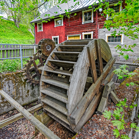 Water wheel with wooden gears in the Vaaksy Water Mill and Hydroelectric Power Station Museum in Asikkala, Finland.のeditorial素材