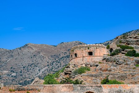 Ruins of main tower of medieval fortress Spinalonga on island Kalydon, Greece.の写真素材