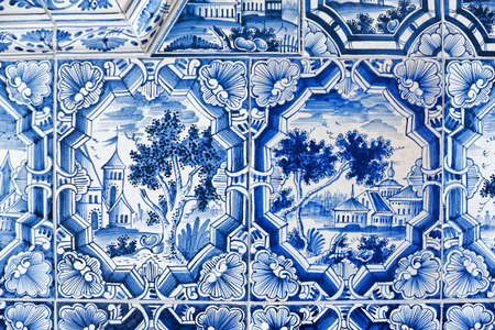 Close-up view to blue white paintings on a tiled stoveの写真素材