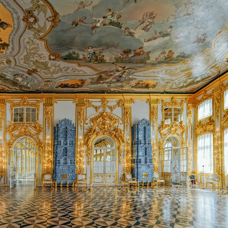 Ornate interior of the Catherine Palace with a multi-tiered tiled stove with cobalt painting. Tsarskoe Selo (Pushkin), St. Petersburg, Russia.のeditorial素材