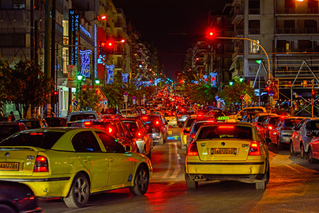 Busy street traffic with many yellow taxis in the center of Piraeus, near Athens, Greece.のeditorial素材