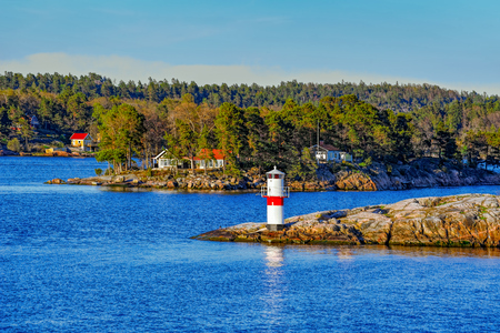 Marine signs and lighthouse in the Stockholm archipelago rocky island to help you navigate in shallow waterのeditorial素材