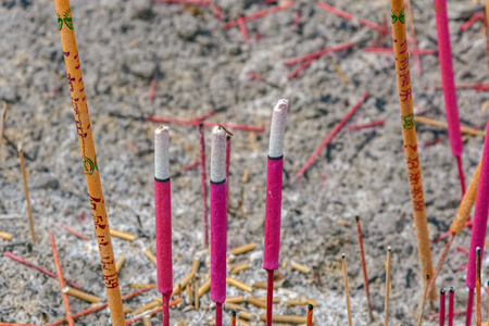 Close-up view to burning incense sticks in pot in Chinese templeの写真素材