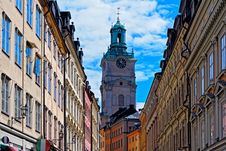 Cathedral of Saint Nicholas (Storkyrkan, The Great Church, Stockholm Cathedral) Bell Tower between buildings of Gamla Stan, Stockholm, Swedenの写真素材