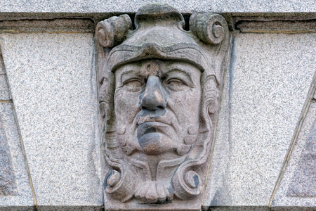 Allegorical mascaron (sculpture picturing a face doing a grimace) by sculptor Gustaf Fredrik Norling and designed by Aron Johansson on the wall of Parliament House.の写真素材