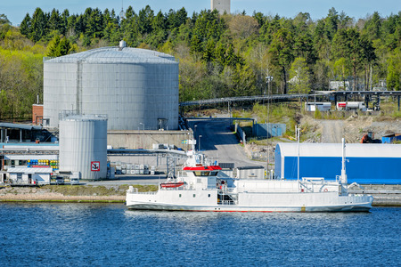 LNG tanker berth on oil product tank depot in Stockholm industrial sea port. Sweden.の写真素材