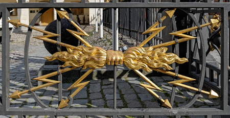 Detail of emblem in shape of fist with lightning bolts on fence of Swedish Army Museum of military history (Armemuseum).のeditorial素材