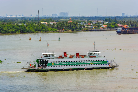 HO CHI MINH CITY (SAIGON), VIETNAM - April 26, 2017: Commuter ferry crossing the Saigon River with full load of walking and riding passengers.のeditorial素材
