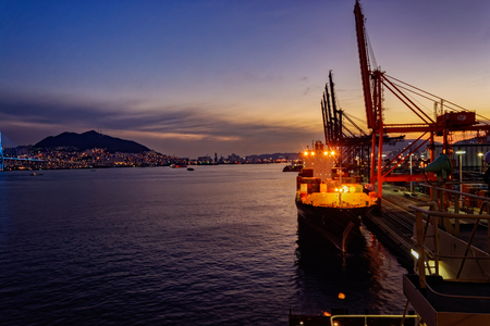 BUSAN, SOUTH KOREA - Jan 21, 2017: Night wide angle panorama of cargo vessel in the port of Busan, South Korea, the fifth largest container terminal harbor in the world.のeditorial素材