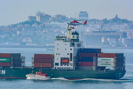 QINGDAO, CHINA - May 15, 2017: Container ship "Uni Promote" conducting a training exercise with a rescue helicopter and harbour pilot boat in Qingdao harbor.のeditorial素材