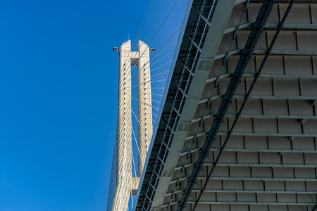 Low angle view to pillar of modern cable-stayed bridge.