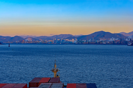 Container ship entering to Port of Gwangyang with bulk carrier ships sit berthed at piers, Jeonnam, Korea.の写真素材